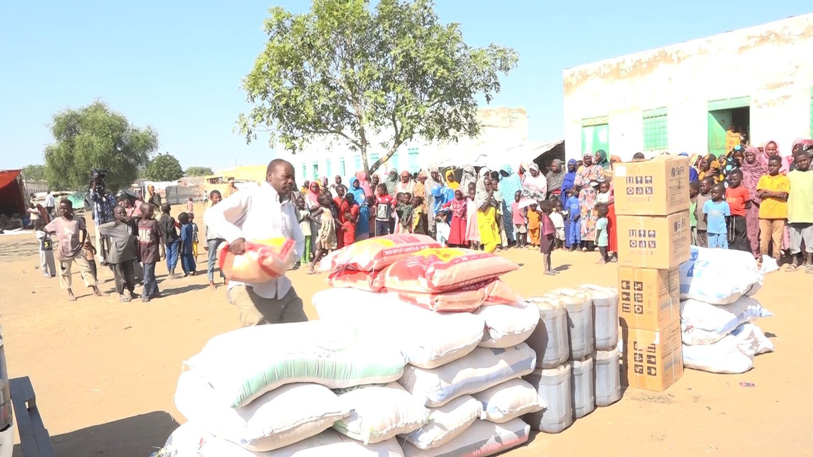 Volunteers distributing food baskets to displaced families in Blue Nile State camps