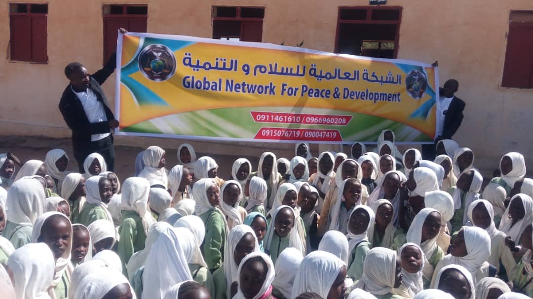 Female students at Al-Khansa Basic Girls School in Damazin receiving school supplies and psychosocial support from Globalnetpd and local partners.
